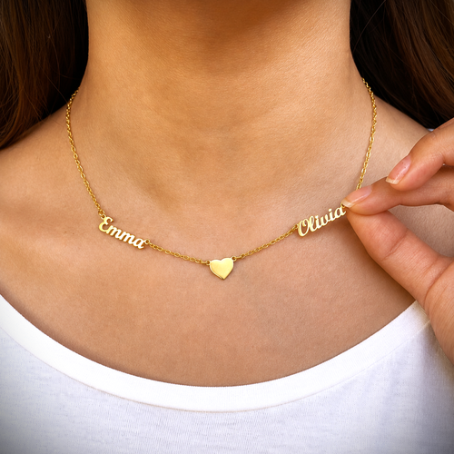Gold necklace with 'Emma' and 'Olivia' on a person wearing a white shirt.
